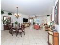 Spacious dining room with a large table and chandelier at 344 Bermuda Ct # 4, Venice, FL 34293