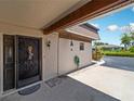 Inviting house entrance with decorative screen door, and paved walkway at 1708 Lakeside Dr # 1710-B, Venice, FL 34293