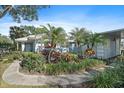 Exterior view of a light blue house with lush landscaping and a paved walkway at 429 Wexford Cir # 75, Venice, FL 34293