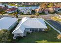 Aerial view of single-Gathering home with tile roof, screened porch, and large backyard at 664 Silk Oak Dr, Venice, FL 34293