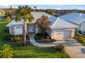 Single-Gathering home exterior, tile roof, two-car garage, and palm trees at 664 Silk Oak Dr, Venice, FL 34293