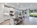 Modern kitchen with island, stainless steel appliances, and white cabinetry at 25442 Kowloon Ln, Punta Gorda, FL 33983