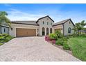 Two-story home with a three-car garage and nicely landscaped front yard at 284 Bocelli Dr., Nokomis, FL 34275