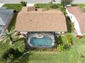 Property boasts a large backyard with a screened pool and lush landscaping at 5006 Southern Pine Cir, Venice, FL 34293