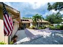 Inviting single-story home with an attached garage, brick walkway, and lovely front yard landscaping at 2521 Northway Dr, Venice, FL 34292