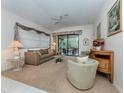 Bright living room with comfy seating and access to a screened patio at 4522 Cancello Grande Ave, Venice, FL 34293