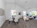 Bright living room with vaulted ceilings, neutral decor, and access to a screened patio at 4815 Tamarack Trl, Venice, FL 34293