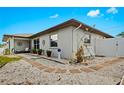 Landscaped side yard with stone pathway and potted plants at 270 Capri Ave, Venice, FL 34293