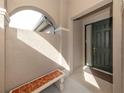 Front entry with a tiled bench and dark-green door at 277 Mestre Pl, North Venice, FL 34275