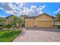 Two-story house with double garage and brick paver driveway at 13587 Vancanza Dr, Venice, FL 34293