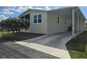 Charming home with a screened-in porch, carport, and a well-maintained front lawn on a sunny day at 428 Boxwood Dr, Venice, FL 34285