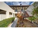 Inviting condo entrance with well-kept landscaping and convenient staircase access to upper levels at 766 Avenida Estancia # 196, Venice, FL 34292
