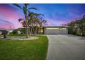 Attractive single-story home with a three-car garage and manicured lawn at 1219 Nantucket Rd, Venice, FL 34293