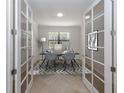 Home office with French doors and neutral decor at 13240 Amerigo Ln, Venice, FL 34293