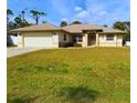 House exterior showcasing a well-maintained lawn at 18194 Driggers Ave, Port Charlotte, FL 33948