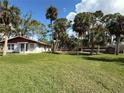House with spacious yard and tropical landscaping at 506 Kenwood Ave, Nokomis, FL 34275