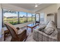 Relaxing sunroom with wicker furniture, offering a tranquil view at 885 Country Club Cir # 61, Venice, FL 34293