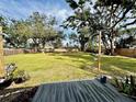 Spacious backyard with deck, lush lawn, and wooden fence at 129 Gulf Ave, Nokomis, FL 34275