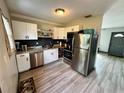 Modern kitchen featuring stainless steel appliances and granite countertops at 129 Gulf Ave, Nokomis, FL 34275
