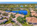 Aerial view of a community with houses and lakes at 1599 Monarch Dr # 1599, Venice, FL 34293