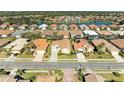 Aerial view of houses in a neighborhood by a lake at 620 Lakescene Dr, Venice, FL 34293