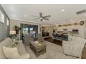 Open living room featuring comfortable seating and views to the kitchen and dining area at 13097 Rinella St, Venice, FL 34293