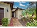 Inviting house exterior with a paved walkway, landscaping, and a two-car garage at 19764 Ortona St, Venice, FL 34293