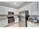 Modern kitchen featuring stainless steel appliances and granite countertops at 20428 Lagente Cir, Venice, FL 34293