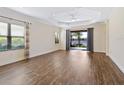 Spacious living room featuring hardwood floors and sliding glass doors leading to a lanai at 21621 Winter Park Ct, Venice, FL 34293