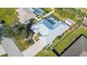 Bird's-eye view showing house, pool, and surrounding area at 23442 Moreland Ave, Port Charlotte, FL 33954