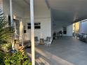 Spacious carport with seating area and doorway access to the home's interior at 789 N Green Cir, Venice, FL 34285