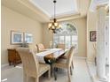 Well-lit dining room featuring a wooden table and six chairs at 824 Blue Crane Dr, Venice, FL 34285