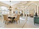 Formal dining room with a chandelier and seating for six at 824 Blue Crane Dr, Venice, FL 34285