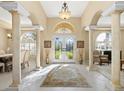 Bright and spacious entryway with high ceilings and elegant columns at 824 Blue Crane Dr, Venice, FL 34285