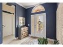 Entryway with decorative wall art and wooden cabinet at 10788 Trophy Dr, Englewood, FL 34223