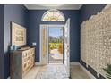 Bright entryway with open door view to backyard at 10788 Trophy Dr, Englewood, FL 34223