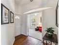 Bright and airy entryway with hardwood floors and view to living area at 2232 Lynx Run, North Port, FL 34286