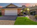 Two-car garage, paved driveway and nicely landscaped lawn at 2232 Lynx Run, North Port, FL 34286