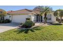 One-story house featuring a tile roof and well-maintained lawn at 444 Pinewood Lake Dr, Venice, FL 34285