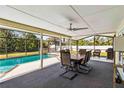 Screened patio with dining table, chairs and a view of the pool at 5172 Rolla Rd, Venice, FL 34293