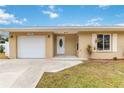 Updated tan house with white garage door at 5296 Rolla Rd, Venice, FL 34293