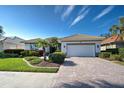 House exterior with a paved driveway and landscaping at 589 Pond Willow Ln, Venice, FL 34292