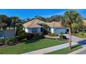 Single-story house with tile roof and palm trees at 589 Pond Willow Ln, Venice, FL 34292