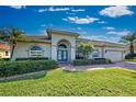 Well-maintained house featuring a large driveway and landscaping at 746 Fringed Orchid Trl, Venice, FL 34293