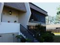 Condo building exterior, showing entrance with stairs and landscaping at 1739 Bonitas Cir # 1724C, Venice, FL 34293