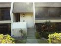 Condo entrance with stairs, showing landscaping and building details at 1739 Bonitas Cir # 1724C, Venice, FL 34293