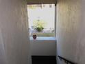 Interior stairwell with a small window overlooking a courtyard at 1739 Bonitas Cir # 1724C, Venice, FL 34293