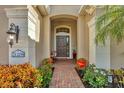 Brick walkway to front door, flanked by planters and lighting at 21208 Sandal Foot Dr, Venice, FL 34293
