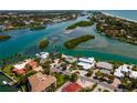Aerial view of waterfront homes, lush landscaping, and beautiful canals leading to the Gulf of Mexico at 922 Casey Cove Dr, Nokomis, FL 34275