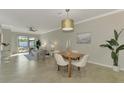 Open concept dining room with view into living room and kitchen at 9847 Haze Dr, Venice, FL 34292
